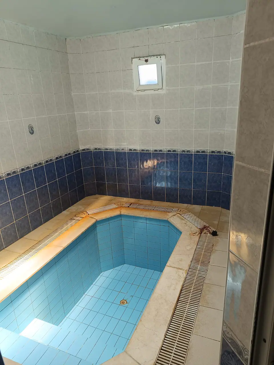 Mermer kenarlı, basamaklı kapalı termal havuz, yukarıdan görünüm